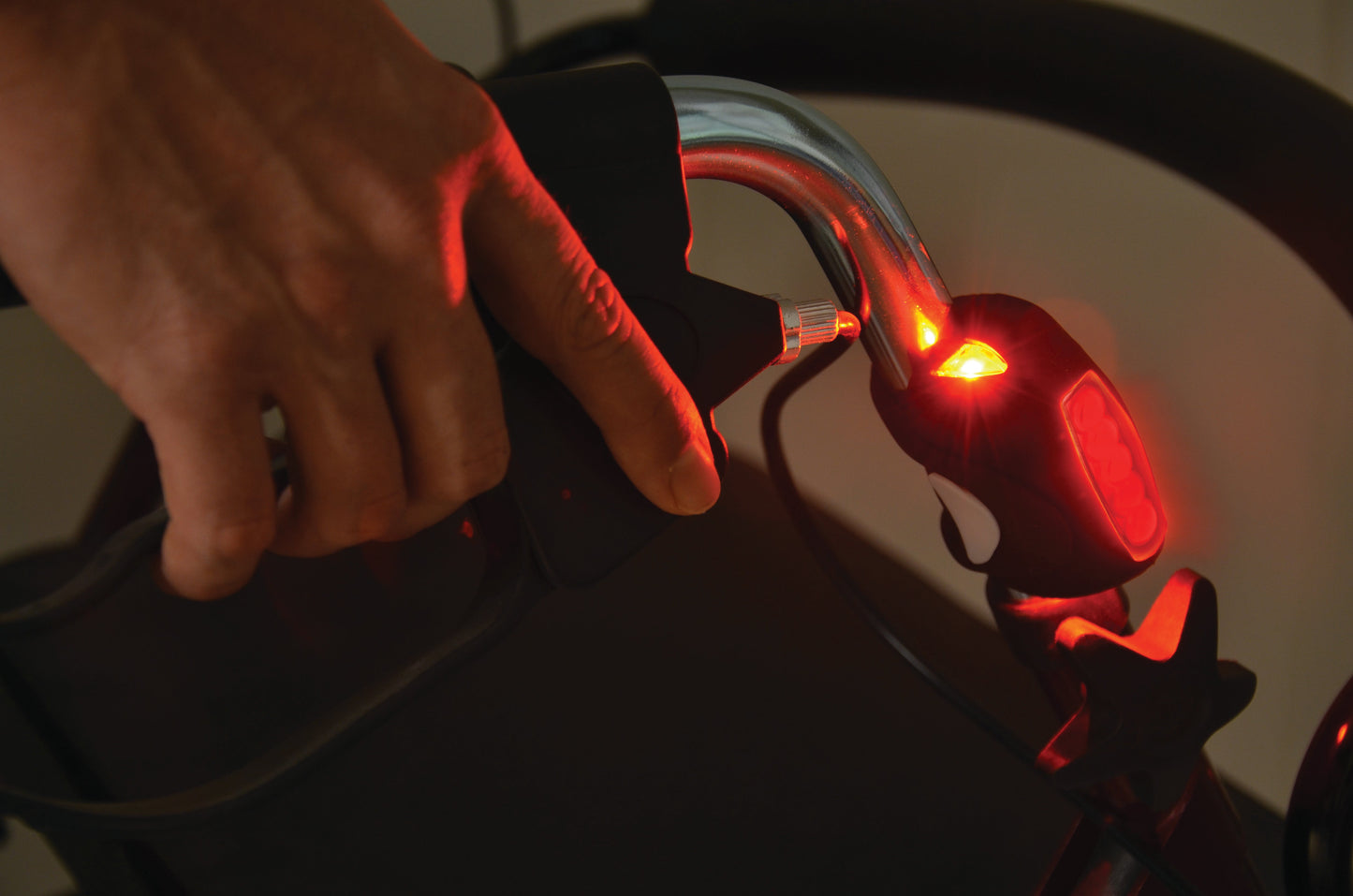 LED light on a bake handle of a walker lit up in red