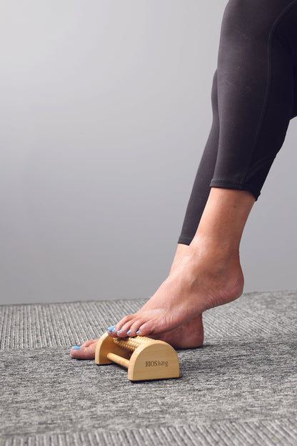 picture of a foot on a wooden foot massager