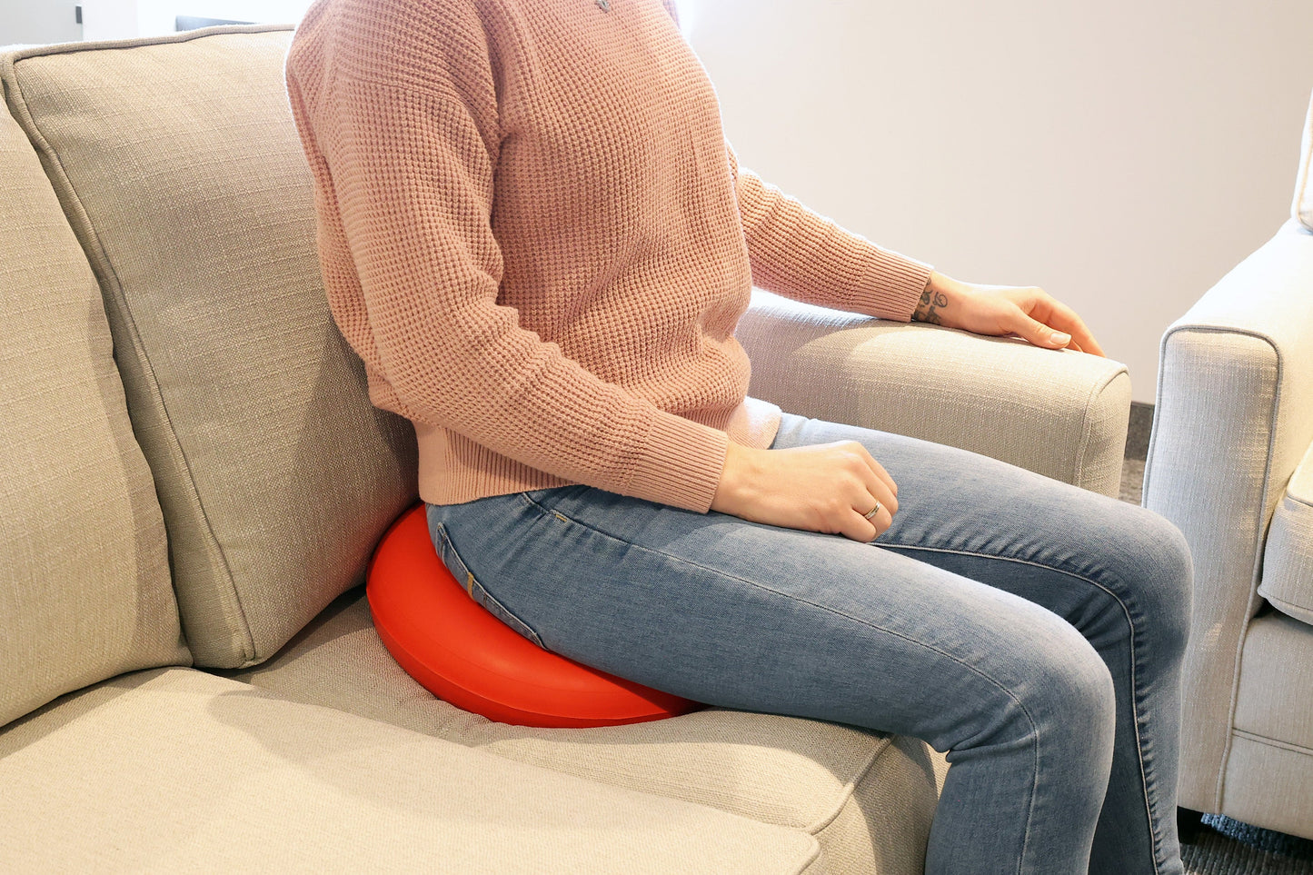 person sitting on the rubber ring on the couch