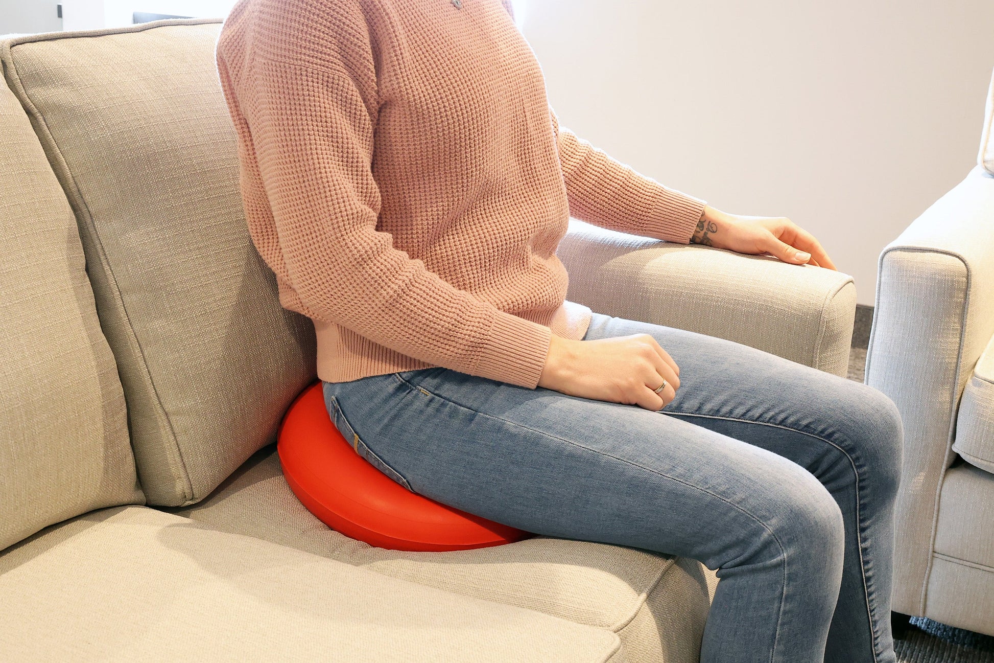 person sitting on the rubber ring on the couch