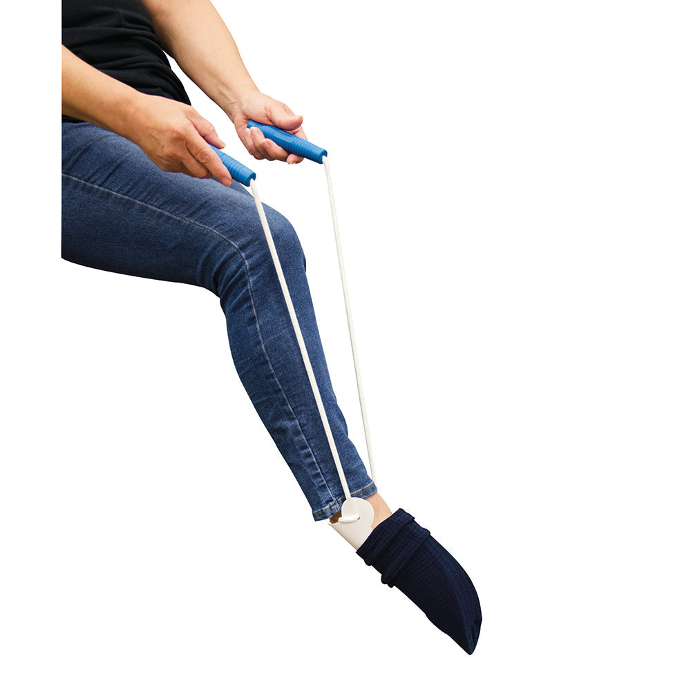 sock aid in use, pulling up a sock onto a foot