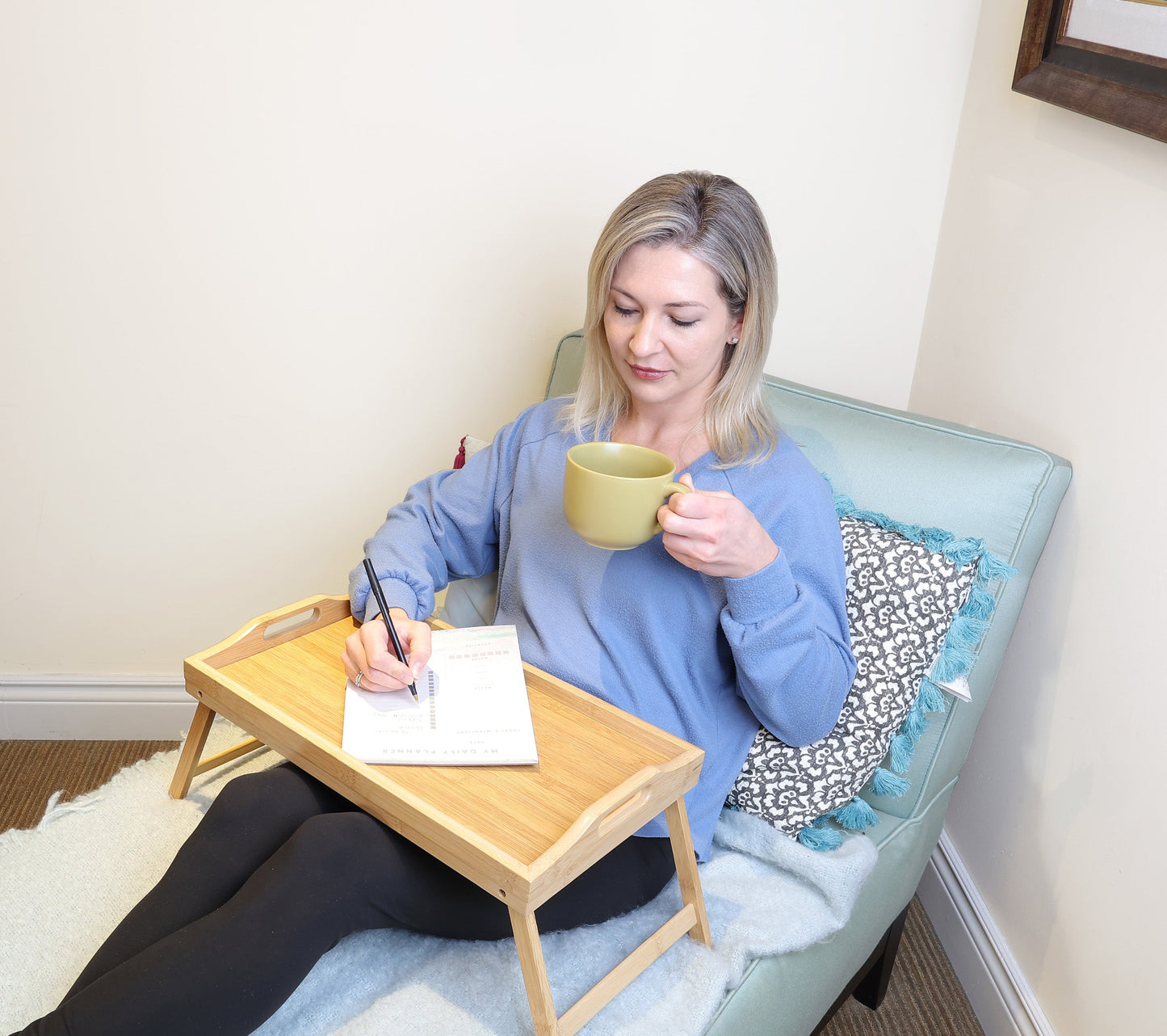 person using the breakfast tray to write notes